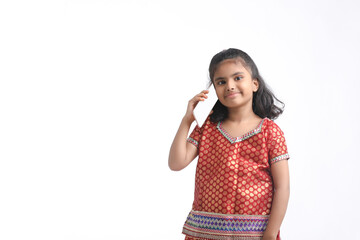 Indian little girl talking on smartphone over white background.