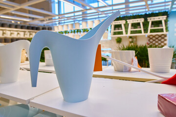 blue watering can for watering indoor plants and flowers