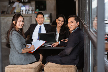 Fototapeta premium portrait of Business people meeting in a cafe smiling to camera