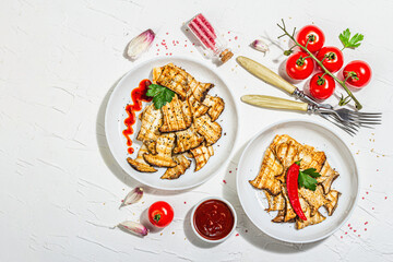 Fried slices Pleurotus eryngii mushrooms with sauce, spices and herbs. Healthy vegan food concept