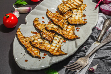 Fried slices Pleurotus eryngii mushrooms with balsamic sauce and sesame seeds. Spices and herbs