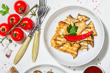Fried slices Pleurotus eryngii mushrooms with sauce, spices and herbs. Healthy vegan food concept