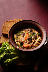 Wild morel mushrooms stewed in sour cream with chili