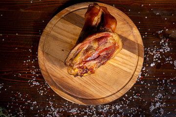 juicy smoked pork shank, delicious meat appetizer, sliced pieces on a wooden board, food,copy space