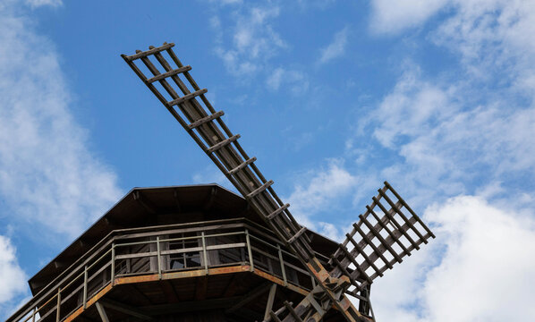 Blades of an old wooden mill against the background of the sky. Old traditions, close-up