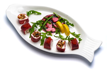 Beetroot pancakes with caviar, eel and arugula, beetroot rolls with seafood, vegetable rolls with fish