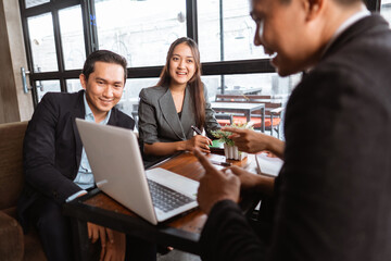 asian business people meeting in cafe with partner and colleagues