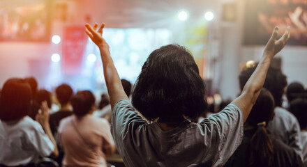 Christian people worship God together.Soft focus of Christian worship with raised hand. - obrazy, fototapety, plakaty