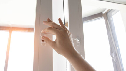 Protection against children on a plastic pvc window. Safety from children falling from the window. Close-up, sun