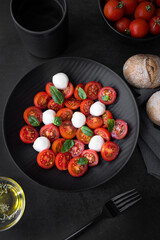 Cherry tomato salad with mozzarella cheese and fresh basil. Delicious vegetarian salad