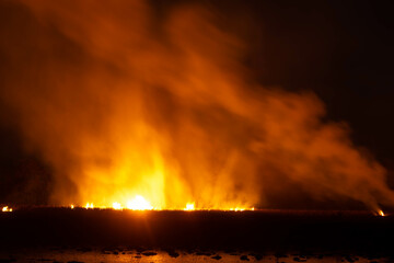 The flames were burning violently in the night fields.