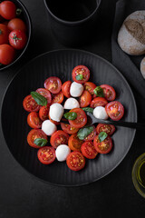 Cherry tomato salad with mozzarella cheese and fresh basil. Delicious vegetarian salad