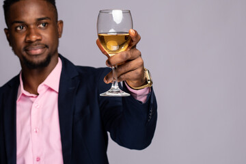 black man raising a glass of wine close up