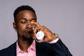 young black man sipping wine