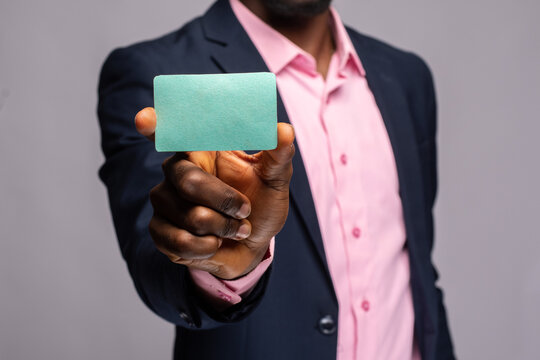 an african businessman showing a plain card