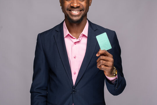 smiling african businessman showing a blank card
