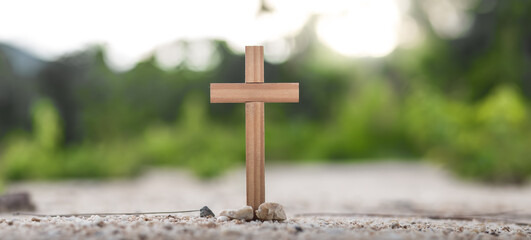 The cross of easter, resurrection concept. Christian wooden cross on a background with dramatic...