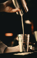 Fototapeta na wymiar man bartender hand making cocktail in bar