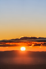 Obraz premium sunset over the mountain and clouds