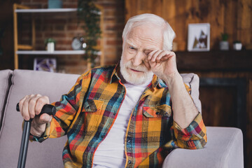 Photo of depressed stressed man pensioner wear checkered shirt holding walking cane crying sitting...