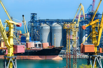 industrial infrastructure of seaport, sea, cranes and dry cargo ship, grain silo, bulk carrier...