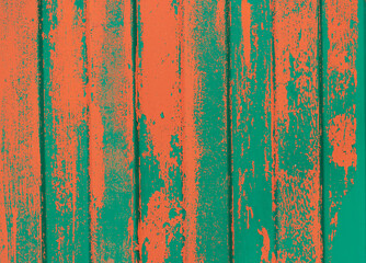 green fence with splashes of orange paint as a background