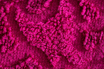 texture of burgundy terry towel with a pattern, close-up. Background, vinous