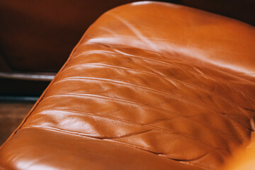 Upholstery of the seats in the car interior is leather with neat stitches.