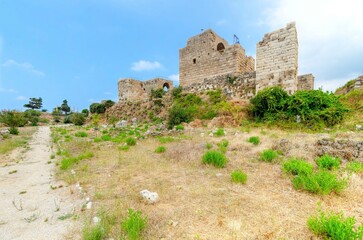 Fototapeta na wymiar The crusaders' castle in the historic city of Byblos in Lebanon. A view of the western walls and a path leading to the east of the ancient site discovered in the area.