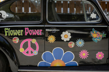 Blumen und Friedenssymbole auf Autotüren in Matala, Griechenland
