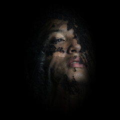 Beautiful girl behind of transparent veil