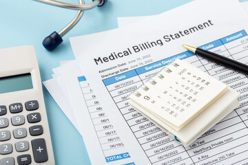 Calendar on medical billing statement with pen