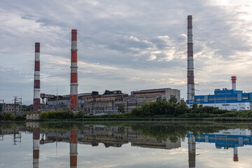 Fototapeta na wymiar old factory stands near the lake