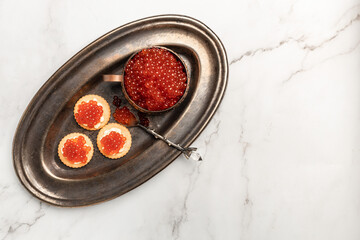 Delicious red caviar appetizer cracker, butter and red caviar. banner, menu, recipe. selective focus, place for text