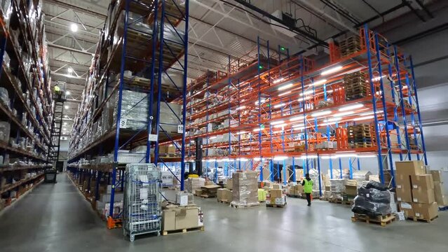 People work in a large warehouse. Timelapse in a modern warehouse. People work in a warehouse timelapse. Work with a modern warehouse