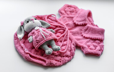Fototapeta na wymiar Beautiful baby knitted clothes and a toy for a newborn baby