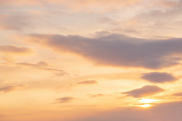 Beautiful sunset sky background with clouds and sun. Bright sunshine. Picturesque cloudscape.