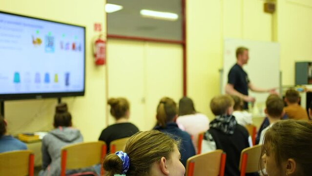 Kids listening to their teacher in school