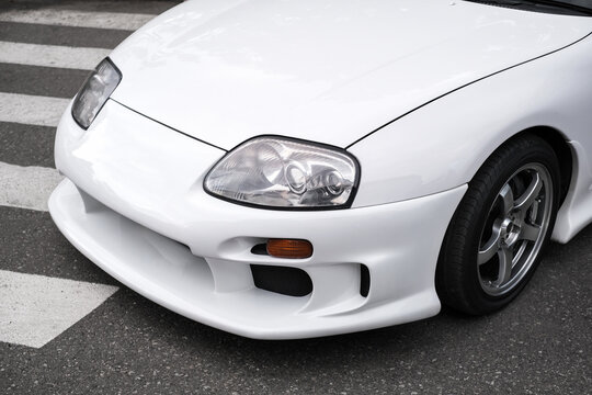 front headlight of white sport car close-up