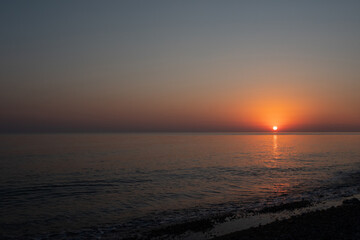 Fototapeta premium Pink sunset in the sea, gentle romantic natural background. Unity with nature