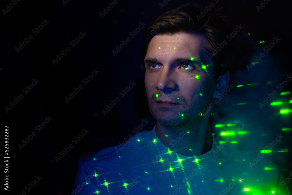 Fototapete creative idea, concept. a young man and a projection of colored patterns on the smoke. technologies 