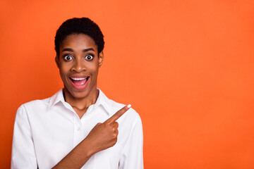 Photo of nonbinary trans person excited expression promote product option offer isolated on orange color background