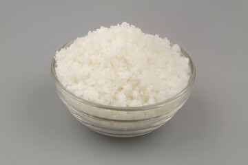 Sea salt in bowl on gray background close-up