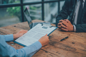 Application for jobs and interviews concept, female is hoping for a resume and recruiter considering application, hr manager making hiring decision.