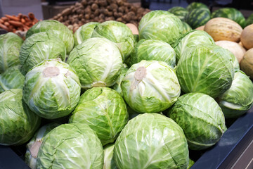 Cabbage heads in the supermarket. Seasonal vegetables from farmers on the market