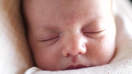 little girl newborn sleeping. portrait a baby close-up sleeping in bed indoors. maternity hospital continuation of the family lifestyle concept. newborn baby sleeping face cute portrait