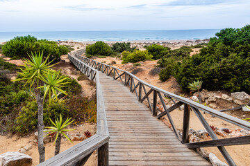 Fototapeta na wymiar wooden walkways, access to La Barrosa beach in Sancti Petri, Cadiz, Spain