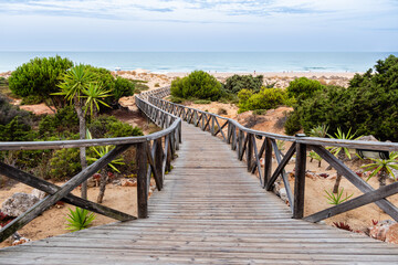 Obraz premium wooden walkways, access to La Barrosa beach in Sancti Petri, Cadiz, Spain