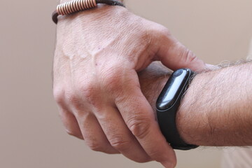 man looking at his smartwatch bracelet 