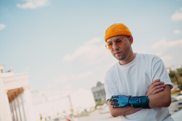 Young disabled man with artificial prosthetic hand in casual clothes